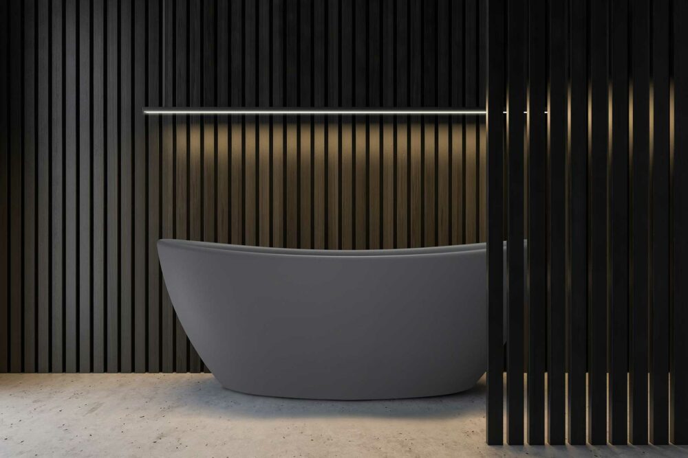 Viena komposittkar fra Interform i grå matt "betong look". spraglete grå betong gulv. Spiler på vegg og i front av badekar. Stor ledbjelke som lyser opp badekaret