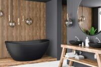 Viena svart badekar fra Interform i svart matt kompositt / solid surface. Spiler / Spilevegg og grå vegg. Hvit armatur og rundt speil.